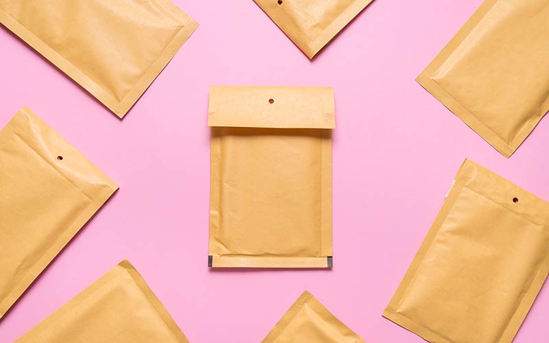 Padded envelopes on a pink background