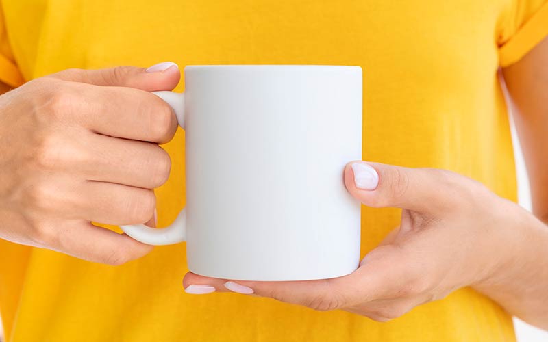 Woman holding a white mug